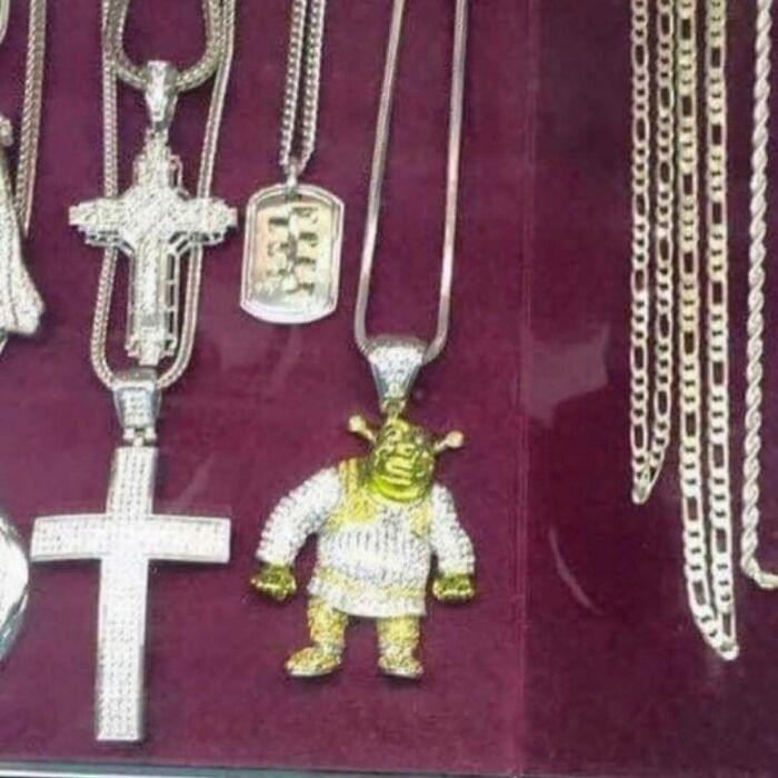 Collection of shiny silver chains and pendants including a detailed Shrek figure, perfect for random photos processing ideas.