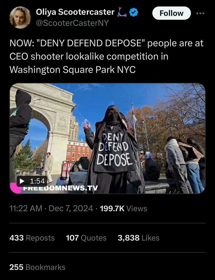 Person in a "Deny Defend Depose" hoodie at an event in Washington Square Park, showcasing world facepalm moments.