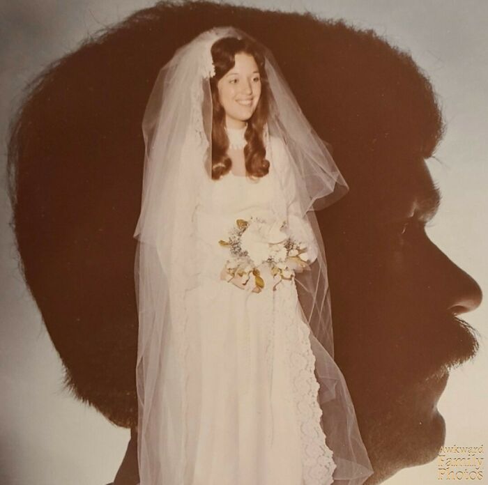 Awkward family photo of bride in veil with superimposed silhouette of man's profile in the background.
