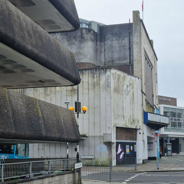 Urban hell: rundown concrete buildings with weathered façades and overcast skies.