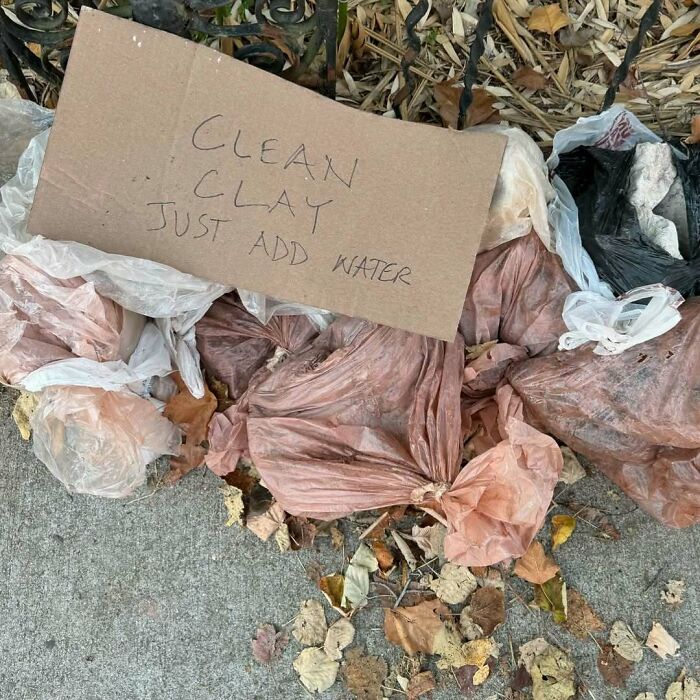 Bags of clay with a sign saying "Clean Clay Just Add Water" left on the curb in NYC for others to find.