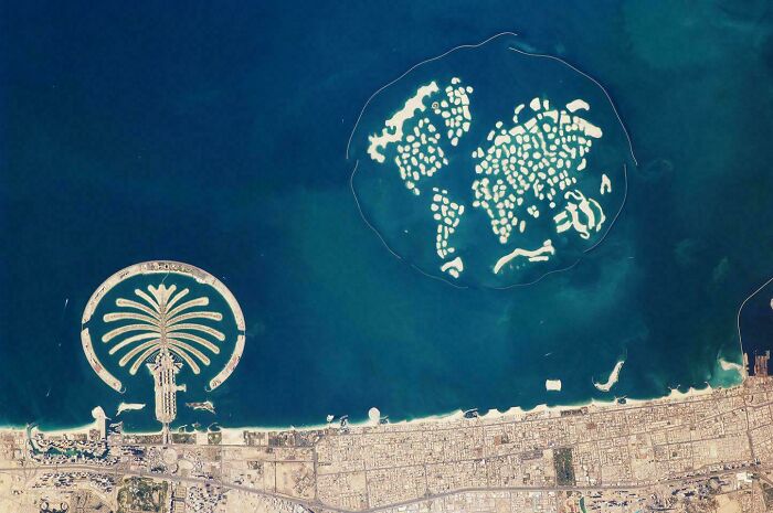 Aerial view of extraordinary urban development resembling a palm and world map in the sea.