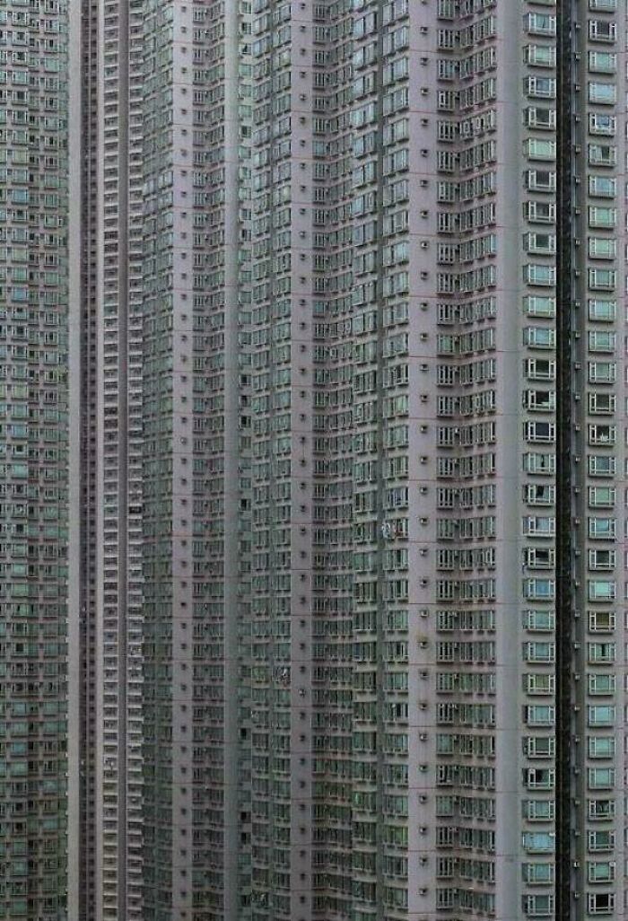 Skyscraper apartment buildings with hundreds of windows showcasing megalophobia in an urban cityscape.