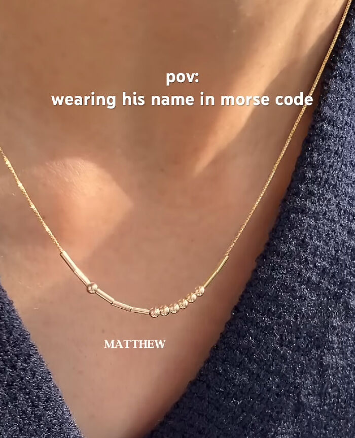 Close-up of a Morse code necklace spelling a name, showcasing a perfectly preventable fail in design or e*******n.