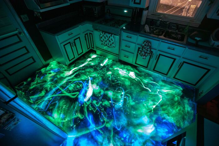 Glowing kitchen floor with blue and green lights creating a fascinating visual effect.