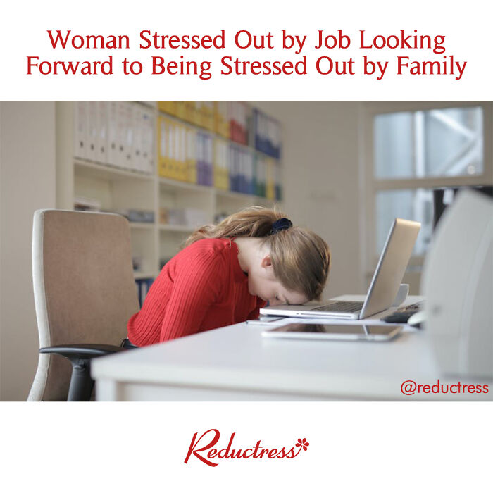 Woman in red sweater stressed at work, with head on desk, captures fake headline humor.
