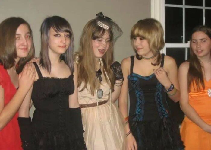 Group of young people in creative outfits during their blunder years at a party.