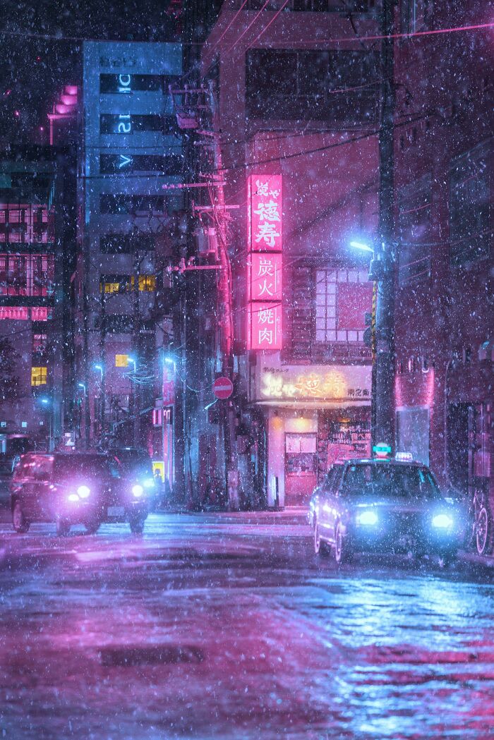 Neon-lit city street in snowfall, showcasing creative street photography at night.
