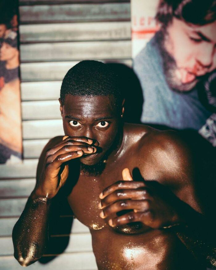 A shirtless boxer posing in a fighting stance, showcasing creative street photography.