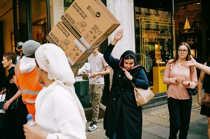 A lively street scene capturing a moment of creative street photography with people interacting dynamically.