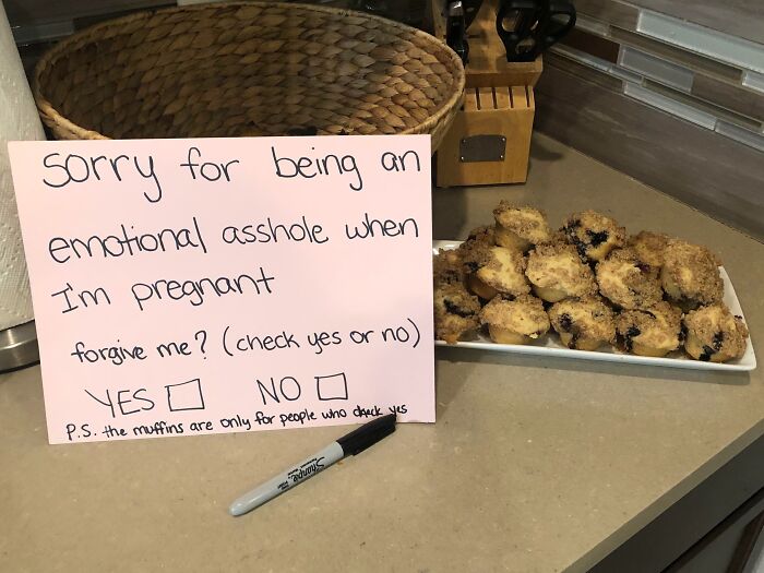 Funny pregnancy apology note next to a plate of muffins.
