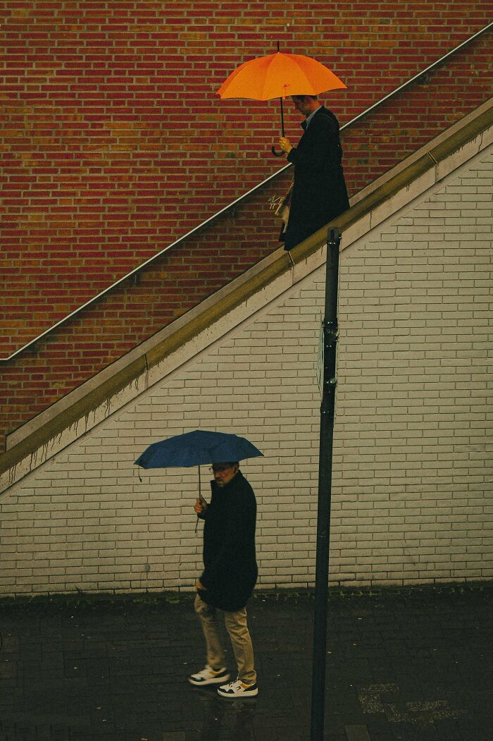 People with colorful umbrellas on a rainy day, showcasing creative street photography dynamics.