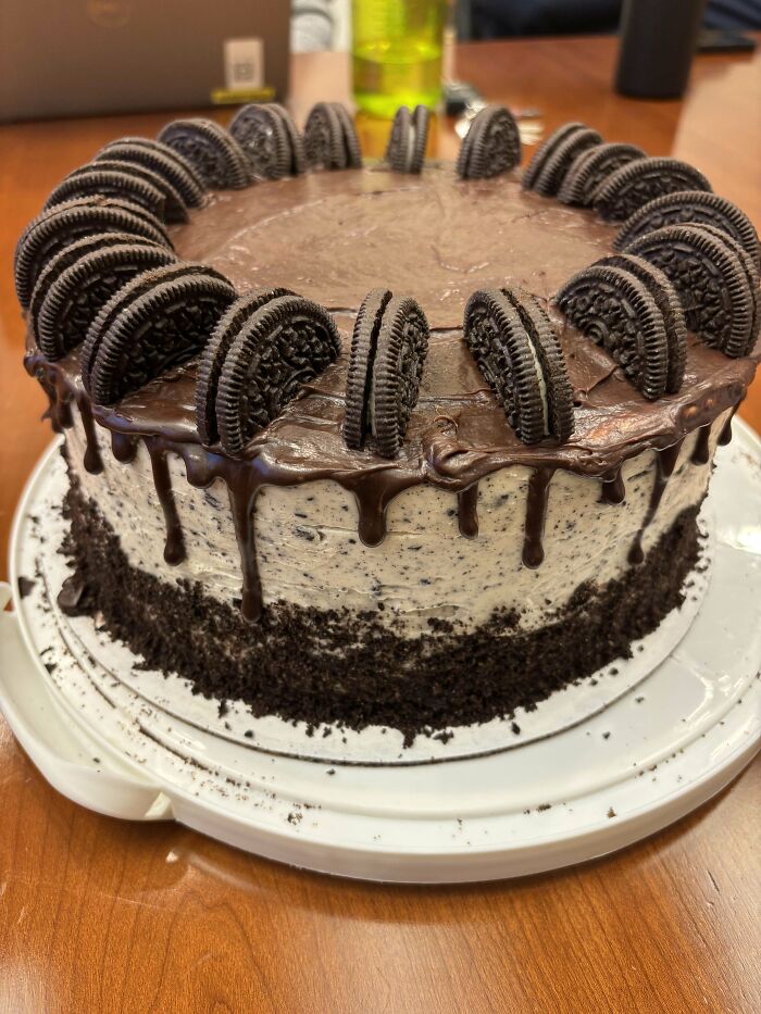 Chocolate Oreo cake with dripping ganache and cookie decor, showcasing bakers' elevated culinary concoctions.