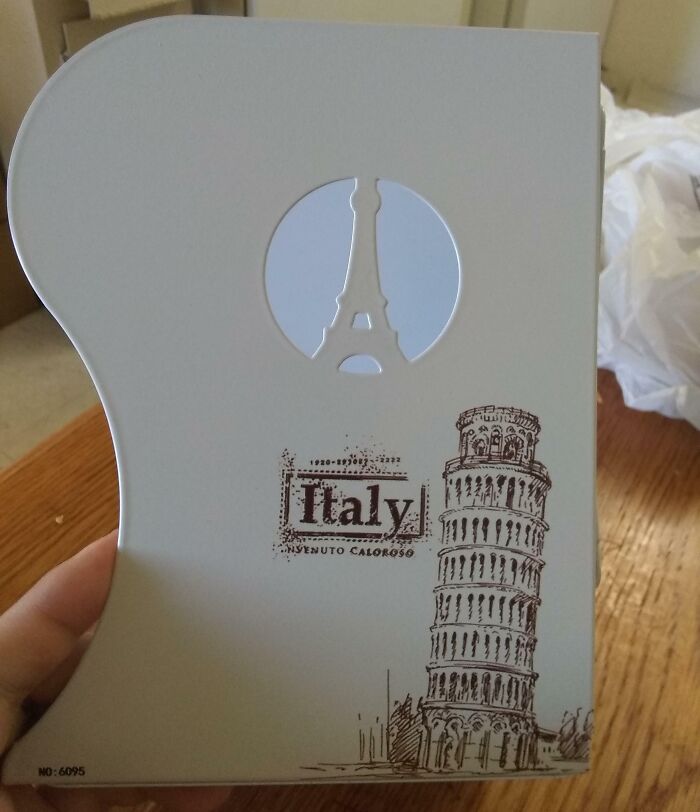 Disappointing gift showing Eiffel Tower on a souvenir labeled "Italy" with Leaning Tower of Pisa.