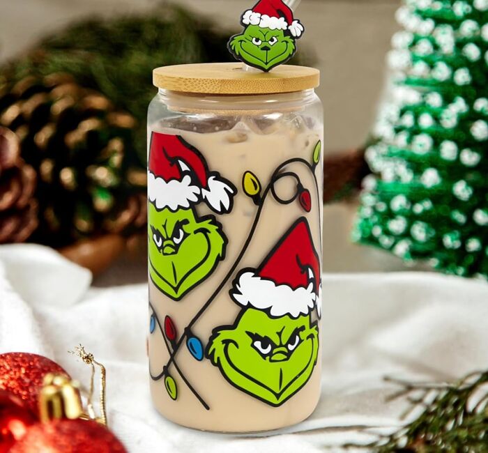 Festive jar with Grinch design, part of mom's viral "Brr Basket" trend, on holiday-themed table.