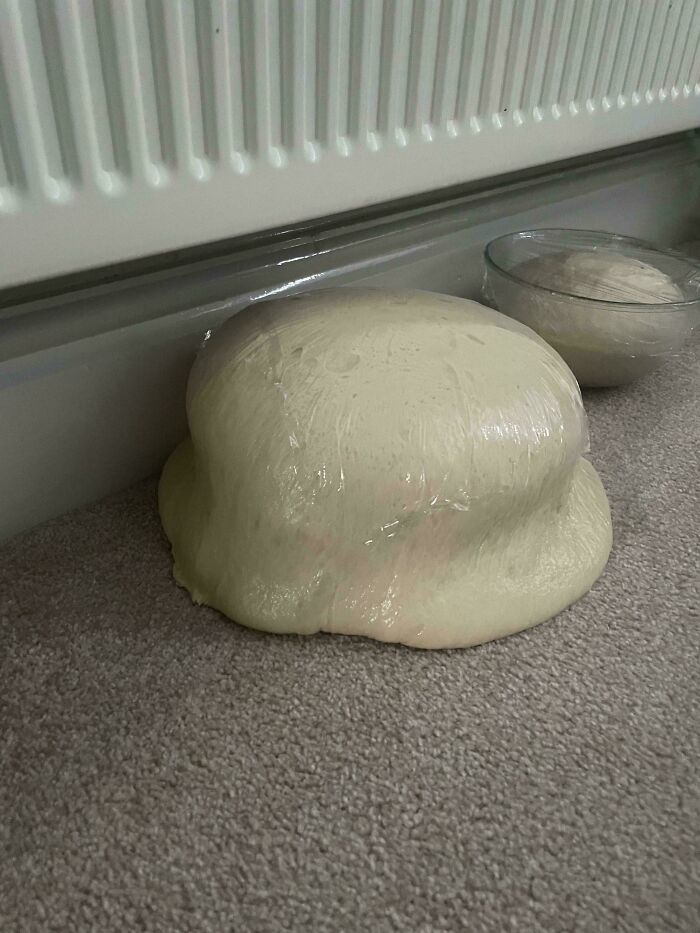Dough rising unusually on the floor, showcasing a creative culinary concoction by bakers.