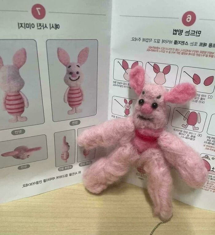 Handmade pink felt DIY disaster figure resembling a bunny, placed in front of instructional craft diagrams.