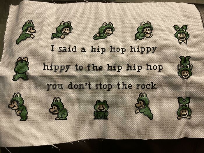 Cross-stitched humorous Christmas gift featuring dancing green characters with lyrics from a hip-hop song.