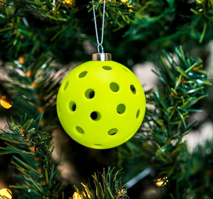 Bright yellow ornament, perfect as a last-minute stocking stuffer, hanging on a Christmas tree.