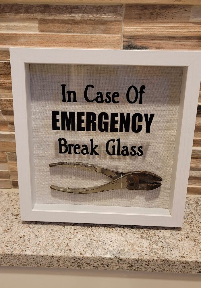 Funny wall decor with pliers, labeled "In Case Of Emergency Break Glass," as a trolling Christmas gift.