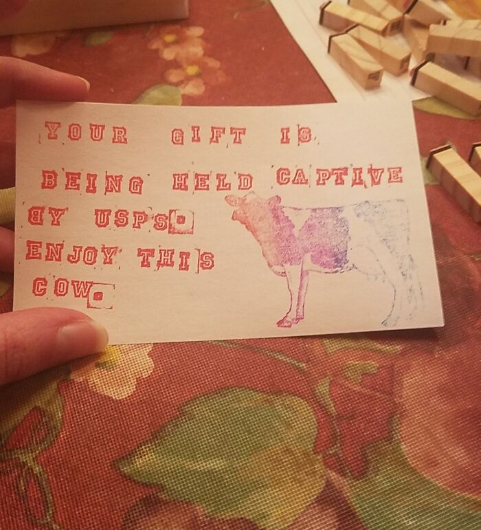 Stamped card with humorous message about delivery, featuring a cow image, representing disappointing gifts.