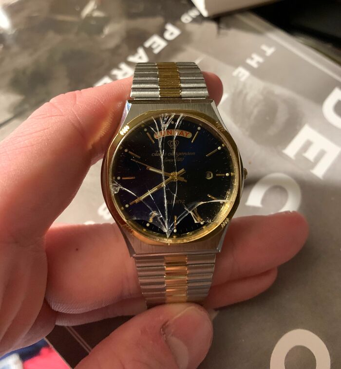 C*****d gold and silver watch face held in hand, symbolizing disappointing gifts.