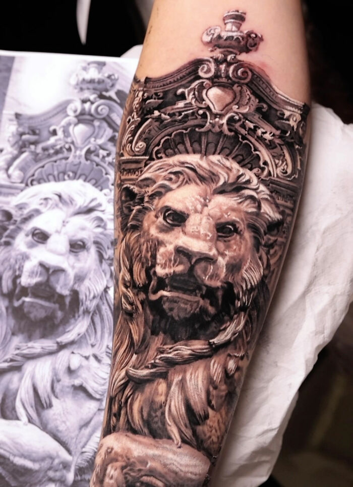 Realistic lion tattoo showcasing mastery in realism art, inked on a forearm, with intricate details matching the reference image.