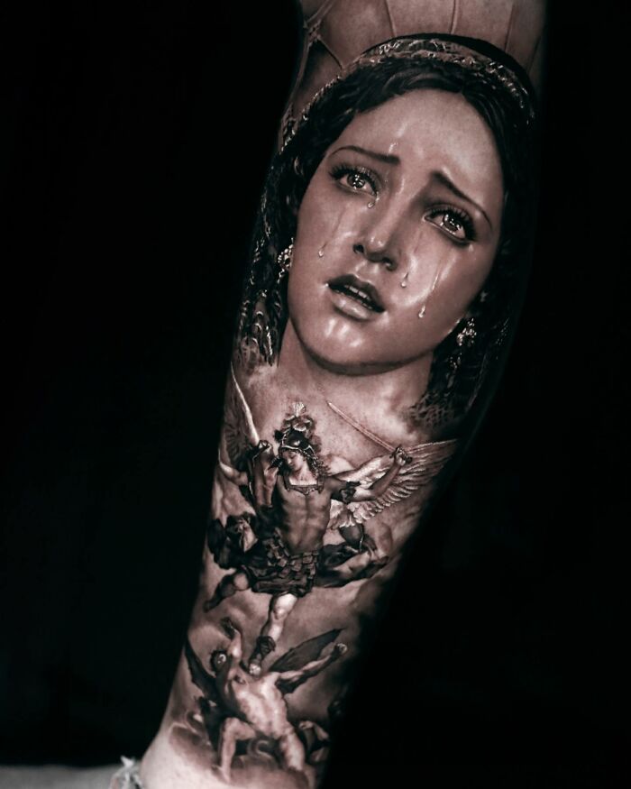 Realism tattoo art depicting a crying woman and angelic figure.