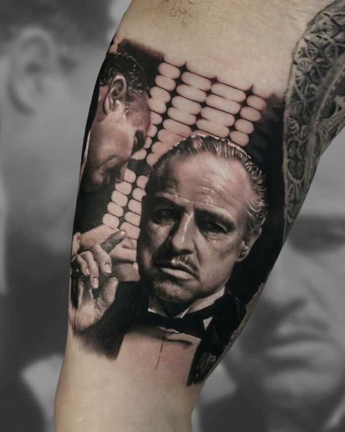 Realism tattoo art by Victoria Lee on forearm, depicting a classic movie scene in intricate detail.