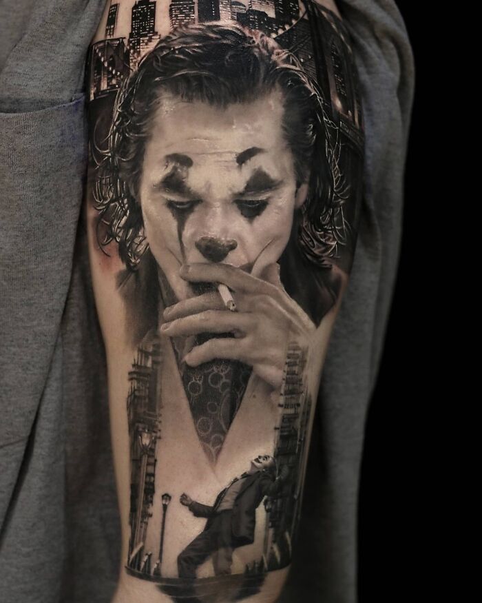 Realism tattoo art depicting a detailed portrait of a character in clown makeup, showcasing mastery in detail.