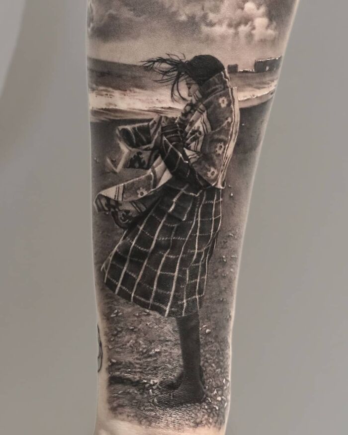 Realistic tattoo of a person in a coat, showcasing Victoria Lee's mastery of illusion and realism in tattoo art.