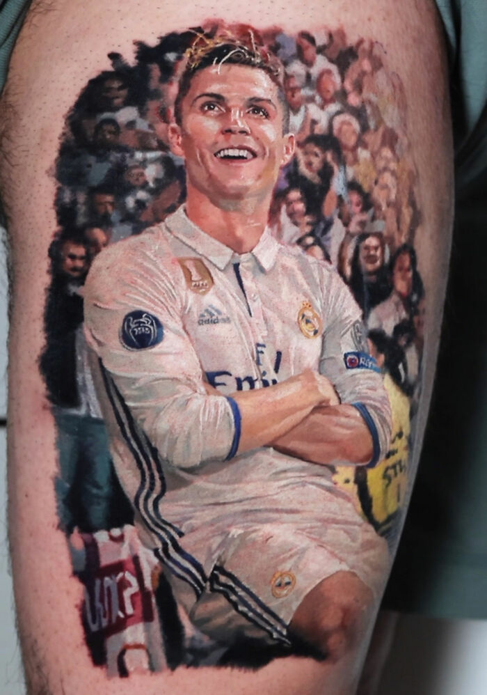 Realistic tattoo art depicting a soccer player in action, showcasing Victoria Lee's mastery of realism.