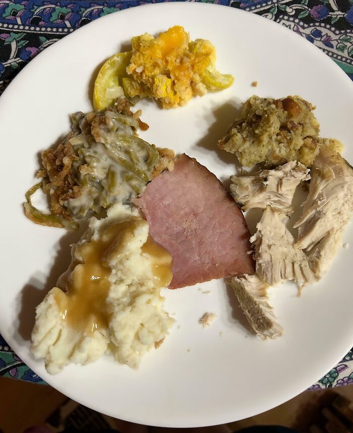 Christmas dinner plate with ham, turkey, mashed potatoes, and squash casserole, highlighting a bad day accident.