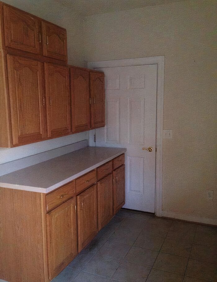 Cheap construction fail with kitchen cabinets blocking the door.