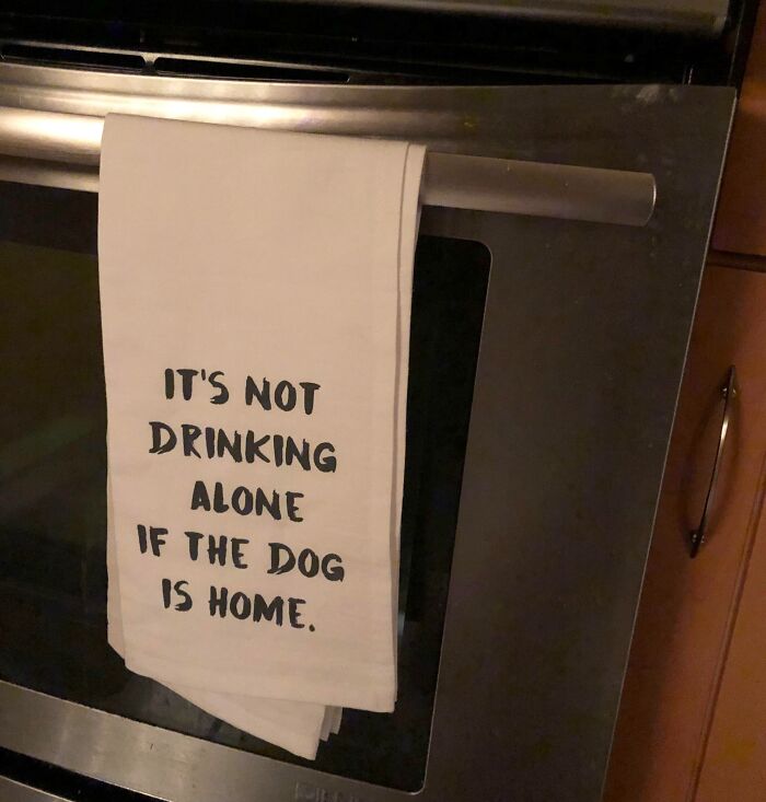 Funny towel with text: "It's not drinking alone if the dog is home," perfect for trolling Christmas gifts.