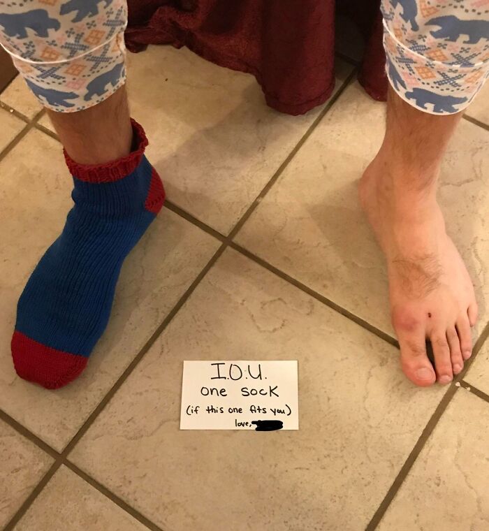 A person wearing one Christmas sock with a humorous IOU note on the floor, showcasing funny Christmas gifts.