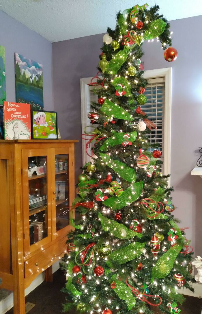 Whimsical Christmas tree decorated with green ribbons and colorful ornaments, inspired by festive holiday ideas.