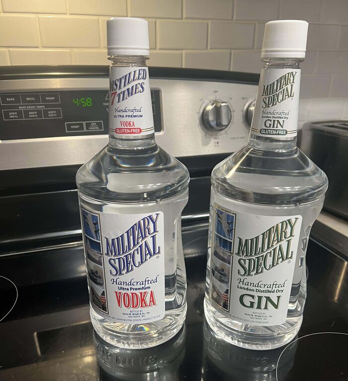 Bottles of vodka and gin labeled as Military Special, perfect hilarious trolling Christmas gifts on a kitchen stove.
