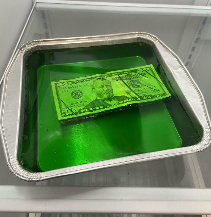 A tray of green gelatin with a $50 bill inside, a perfect example of hilarious trolling Christmas gifts.