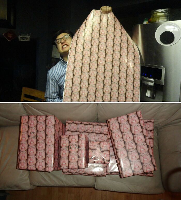 Man holding trolling Christmas gift wrap, face pattern covering presents on couch.