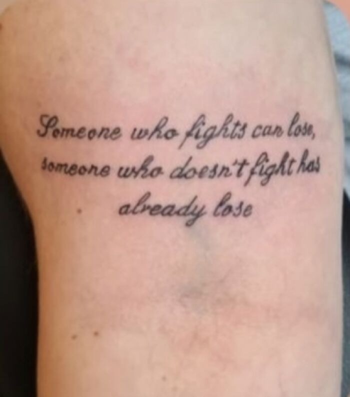 A tattoo with a misspelled motivational quote, showcasing tattoo fails.