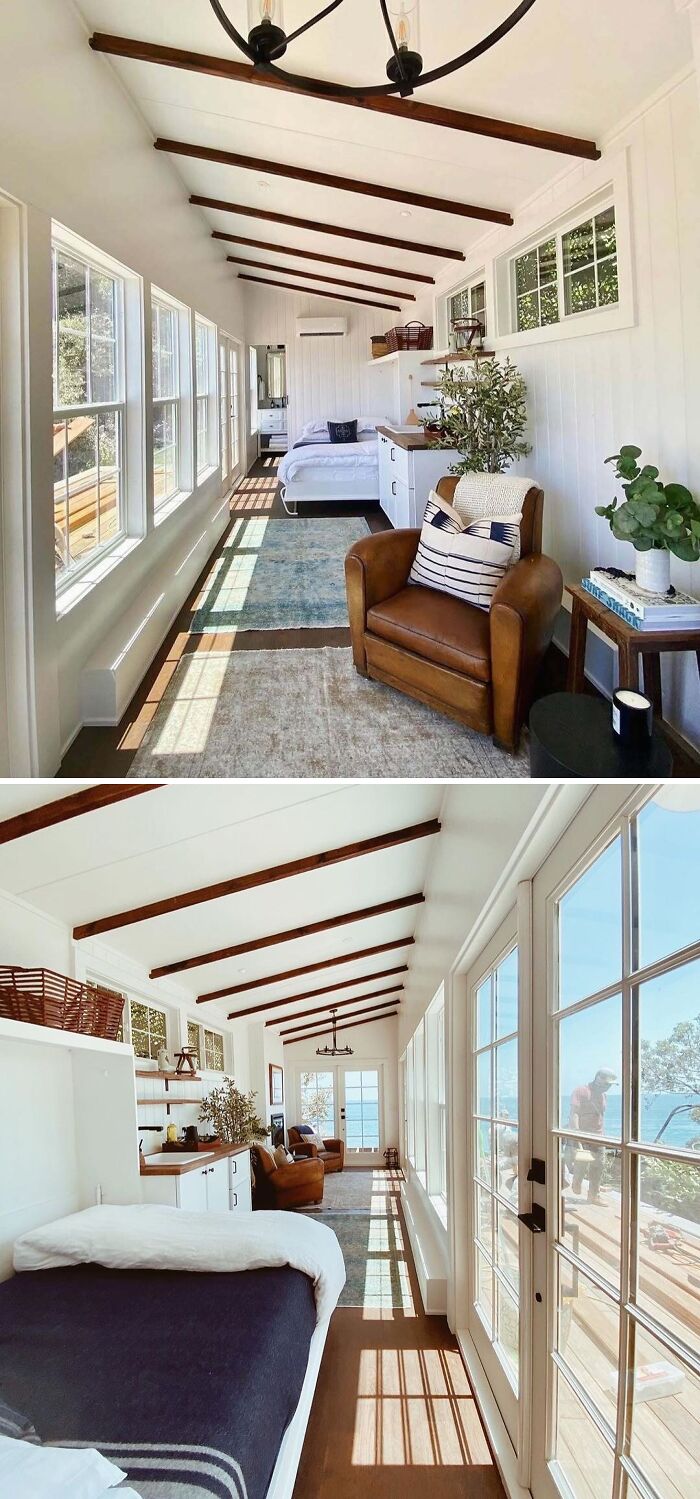 Interior of a stylish, sunlit tiny home with cozy decor and large windows.