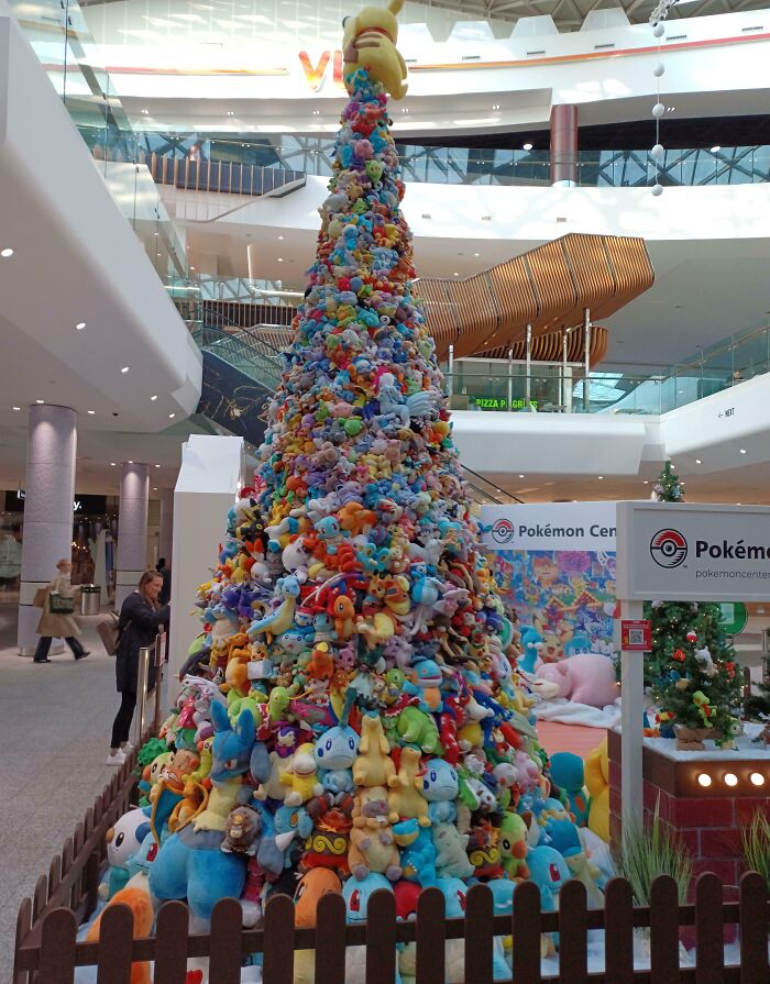 Colorful Christmas tree made of Pokémon plushies in a shopping mall, showcasing creative holiday decoration ideas.