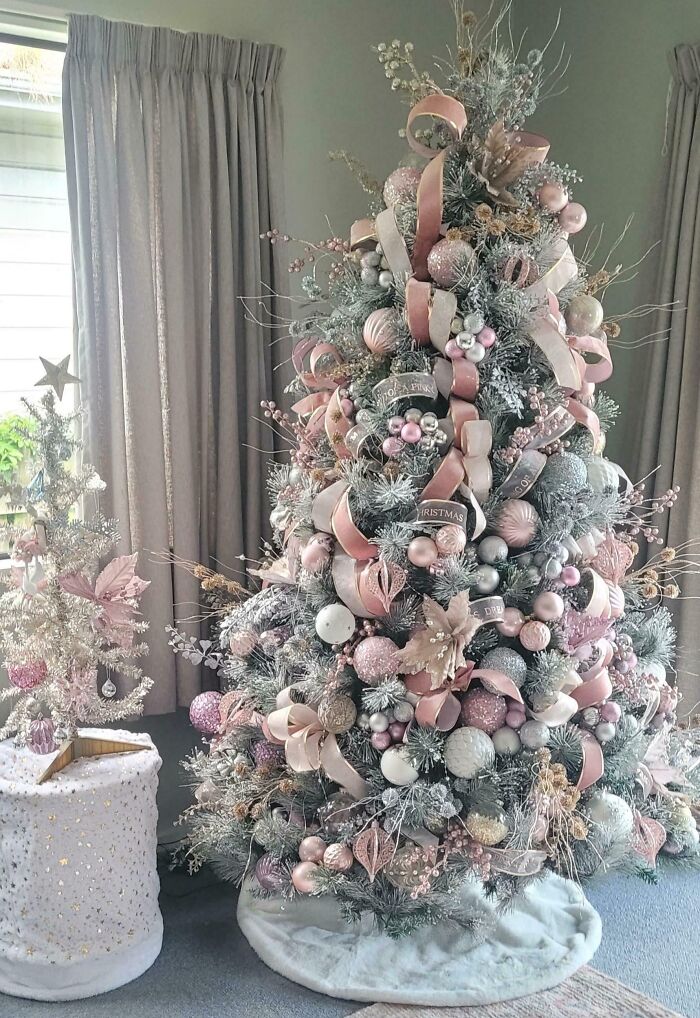 Elegant Christmas tree with pastel pink and white decorations, showcasing a creative holiday design.
