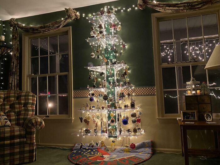 Modern Christmas tree idea with hanging ornaments and lights, set in a cozy living room.
