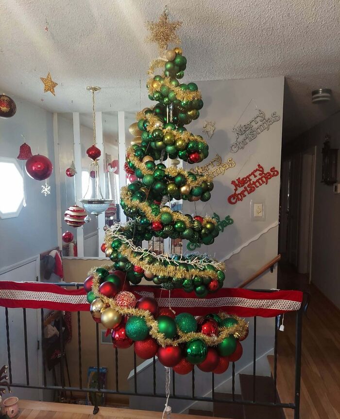 Floating Christmas tree with red, green, and gold ornaments, decorated for holiday festivities.
