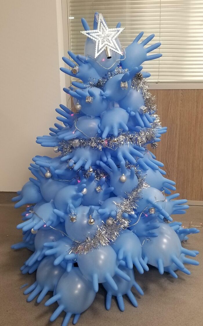 Creative Christmas-tree idea using blue gloves, decorated with tinsel and a star on top.