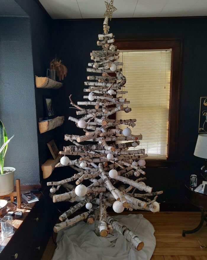 Rustic Christmas tree idea with birch branches and white ornaments in a cozy living room setting.