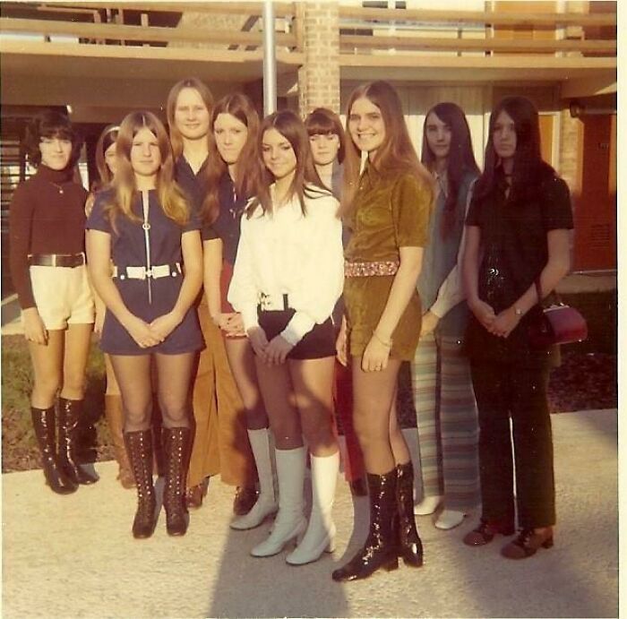 '70s high school girls pose in vintage outfits, showcasing fashion trends of the era.