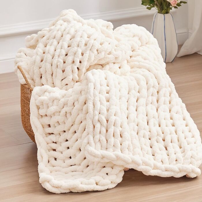 Chunky knit cream blanket in a basket, a cozy Christmas gift perfect for making moms cry happy tears this holiday season